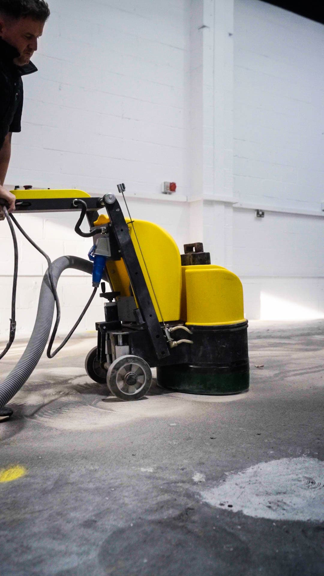 Wide shot of floor grinder in use.