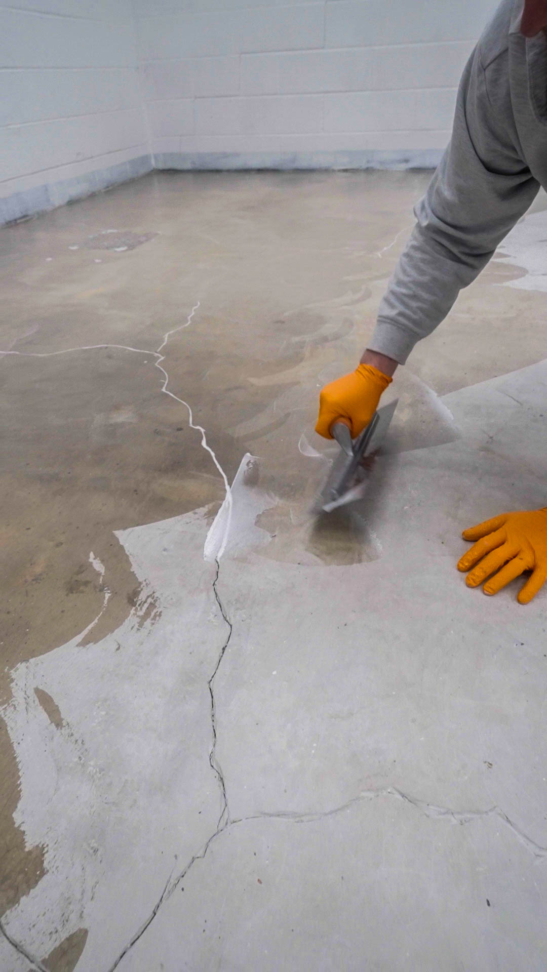 filling and levelling concrete floor cracks as part of resin floor preparation