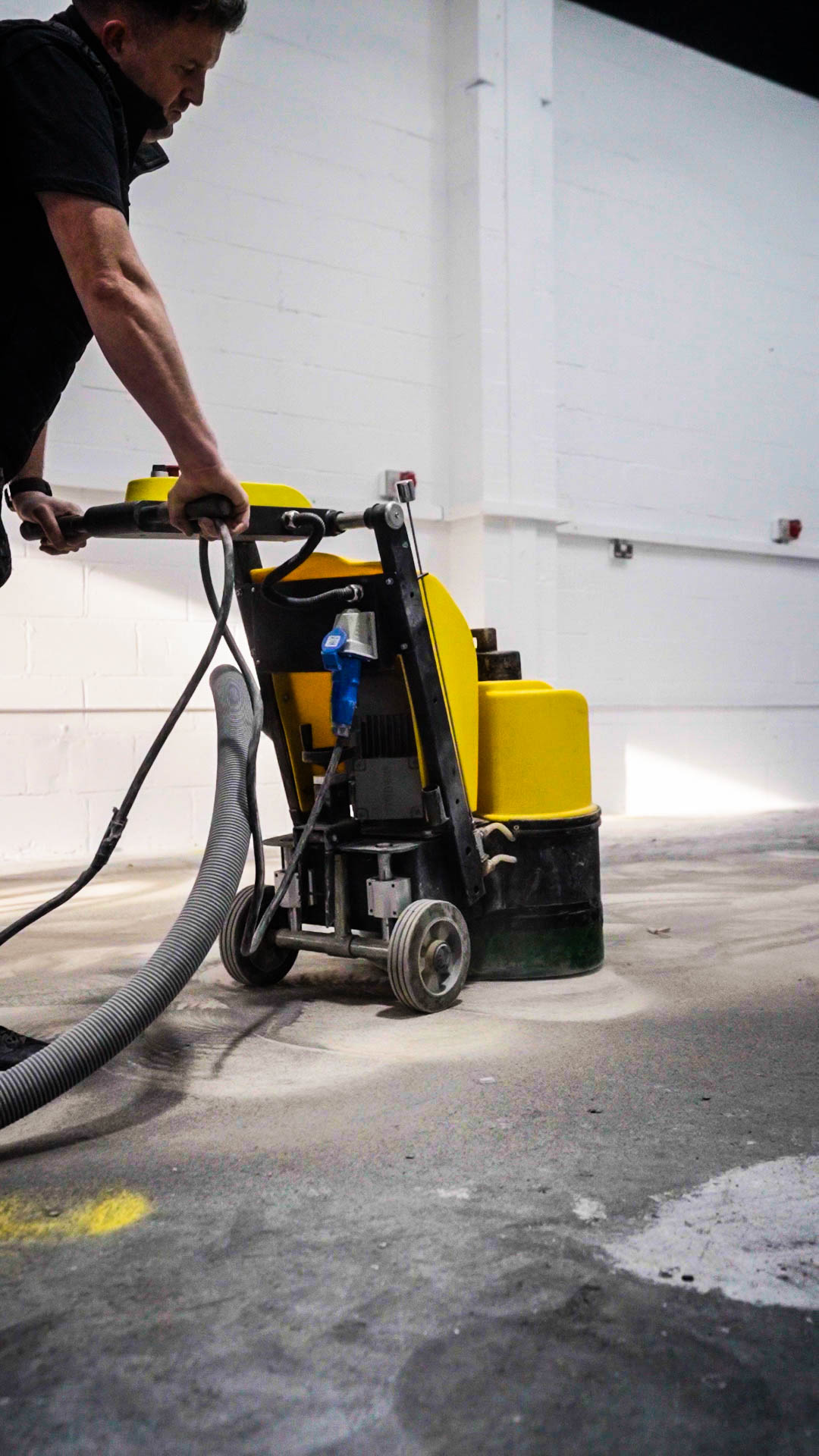 diamond grinding machine profiling commercial concrete floor before resin application